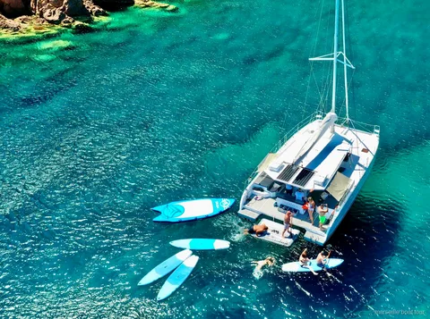 Catamaran on the Marseille calanques tour with standup paddleboards